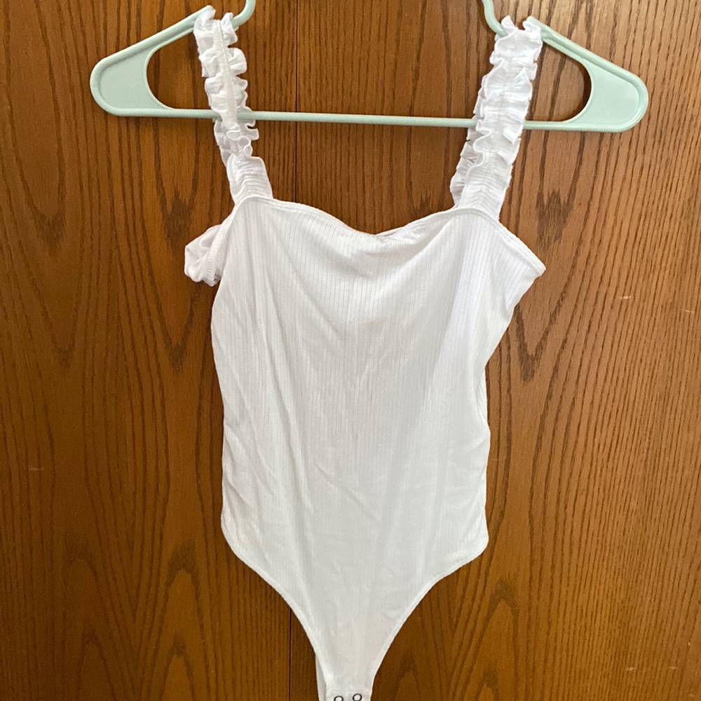 Cute white bodysuit from Hollister with ruffled straps. Never worn.